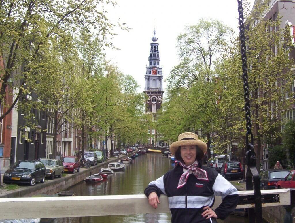 jean standing on a canal bridge in amsterdam