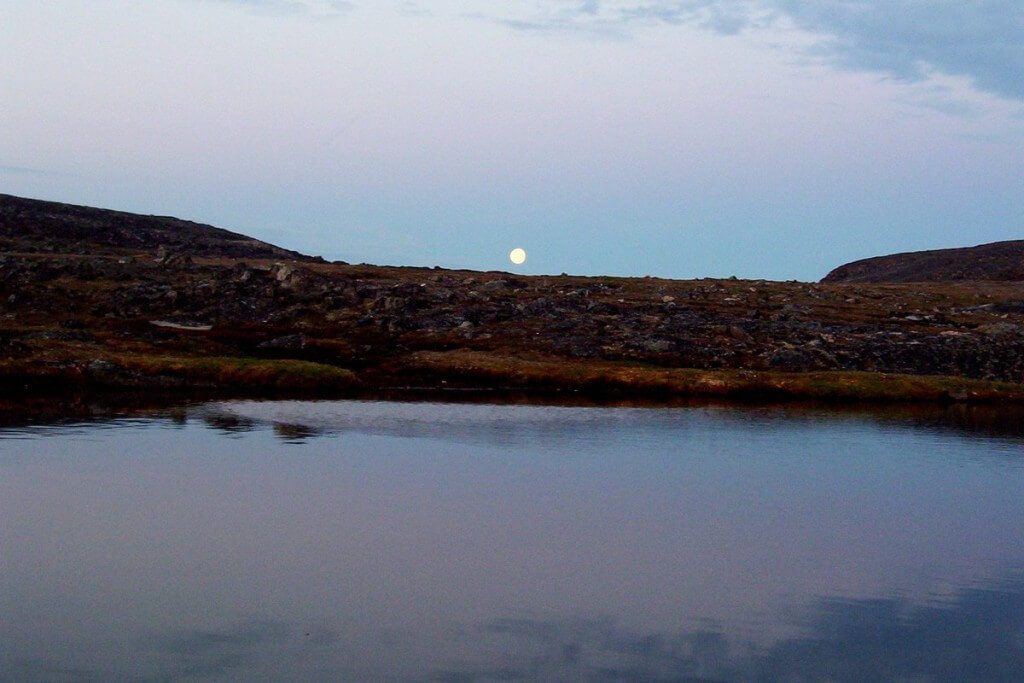 midnight sun on kekerten island, nunavut, canada