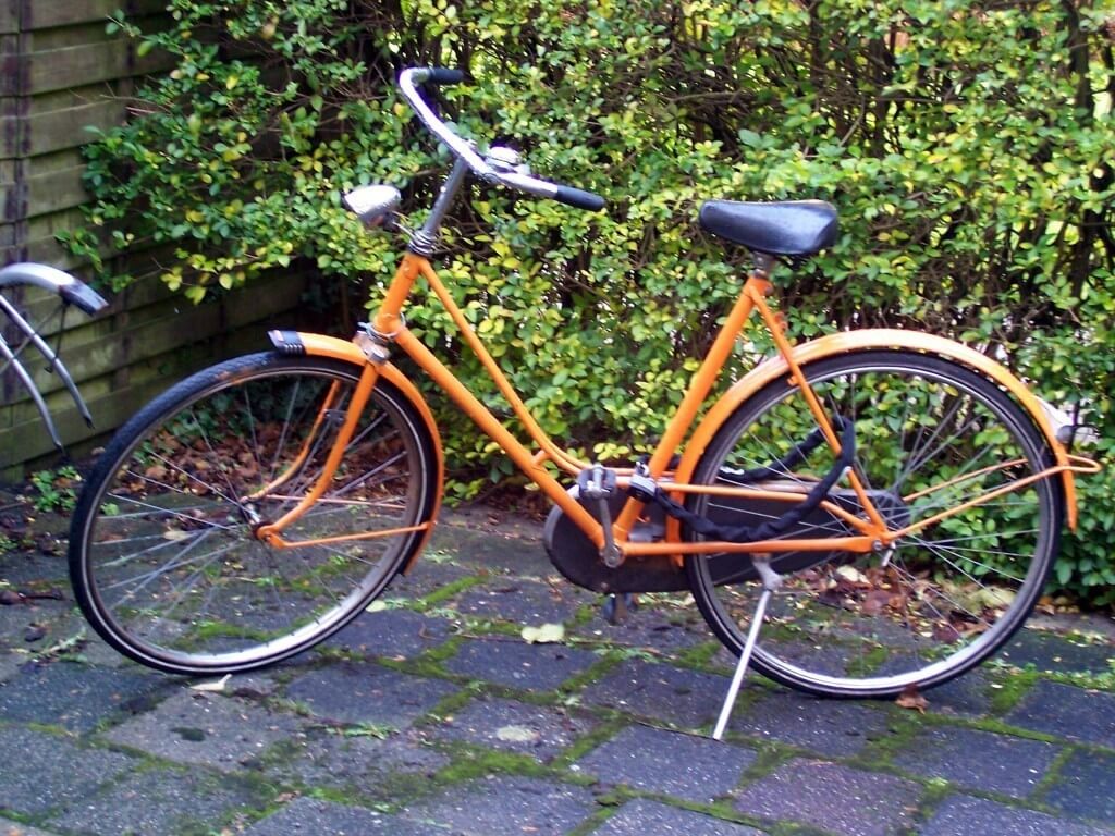 orange colored bike in amsterdam, the netherlands