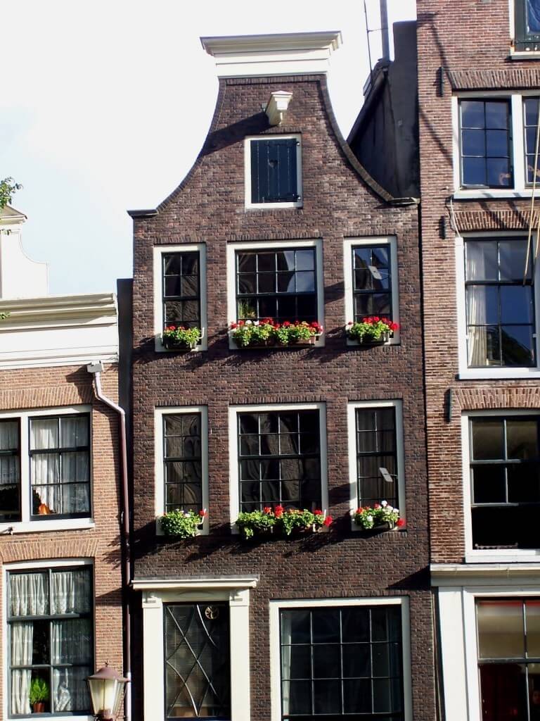 row house along canal in amsterdam