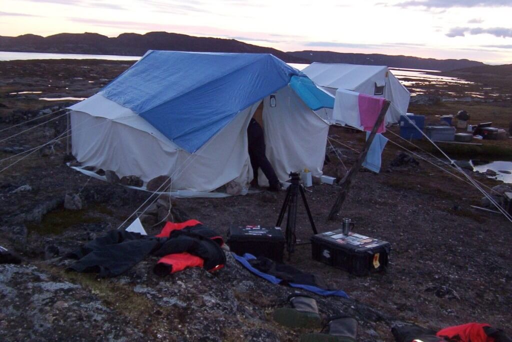 tent and camera gear on kekerten island, nunavut, canada