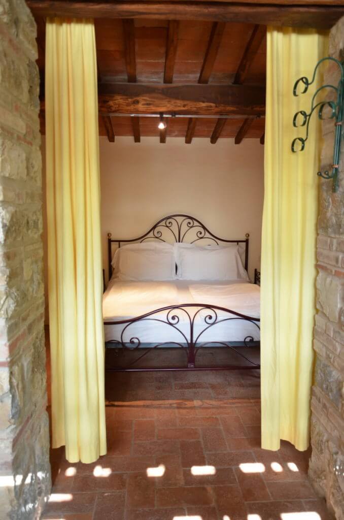 Bedroom in the stone farmhouse at Il Colombaio di Cencio, Gaiole, Chianti, Tuscany, Italy
