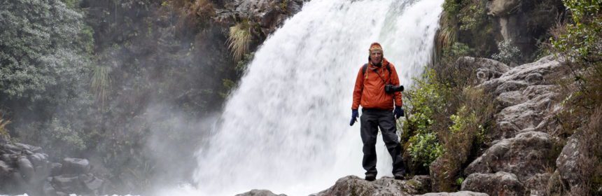 An image of Bob standing below Tawhai Falls in Tongariro National Park in New Zealand. Photography by Frame To Frame - Bob and Jean.