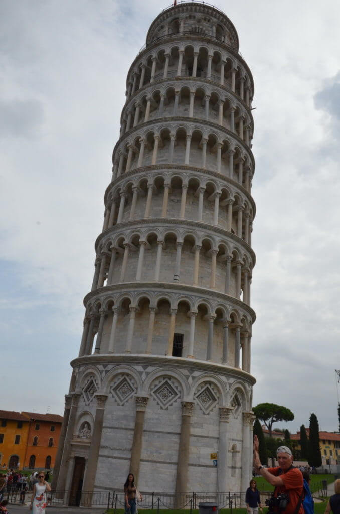 An image of bob pretending to hold up the Leaning Tower of Pisa in Tuscany, Italy. Photography by frame to frame - bob and jean.