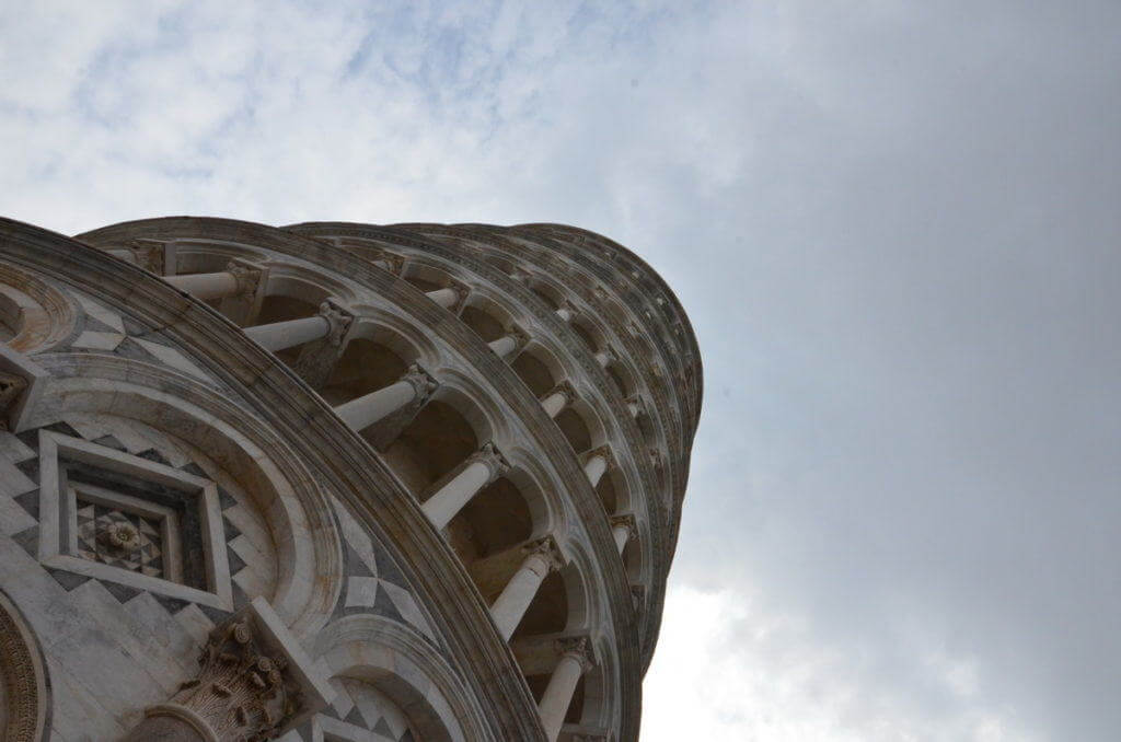 An image of a side view looking upward of the Tower of Pisa in Tuscany, Italy. Photography by Frame To Frame - Bob and Jean.