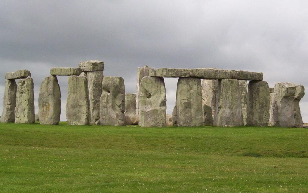 An image of several stone pillars holding up lintel stones on one side of Stonehenge in Wiltshire, England. Photography by Frame To Frame - Bob and Jean