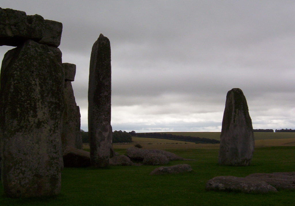 An image of the massive lintel stones sitting on the top of some of the stone pillars at Stonehenge in Wiltshire at dusk in England. Photography by Frame To Frame - Bob and Jean