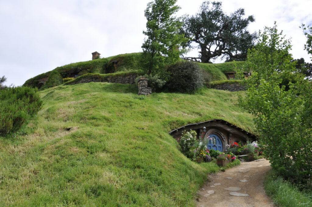 An image looking up towards Bilbo Baggins home high atop Bag End at Hobbiton in New Zealand. Photography by Frame To Frame - Bob and Jean.