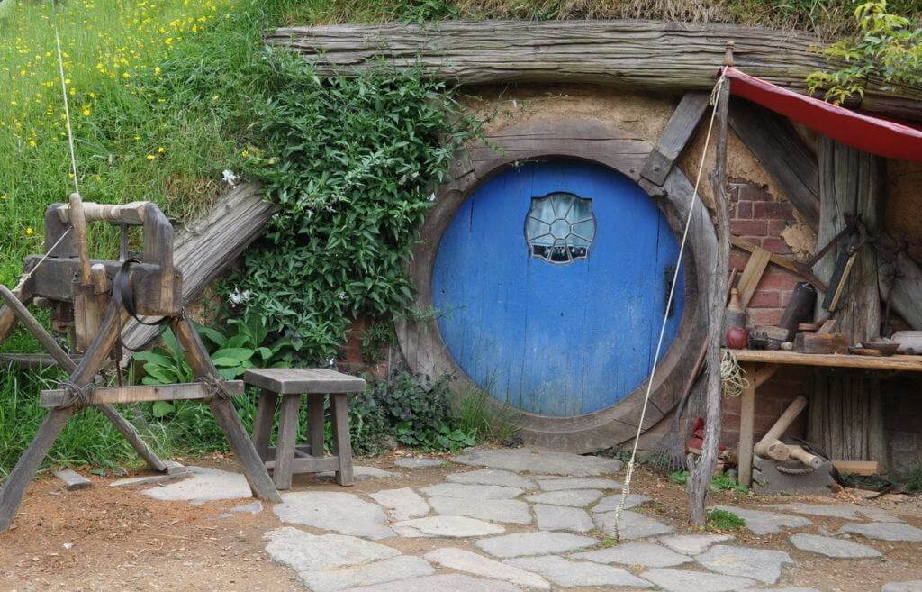 An image of the carpenters hobbit hole with a blue door at Hobbiton in New Zealand. Photography by Frame To Frame - Bob and Jean.