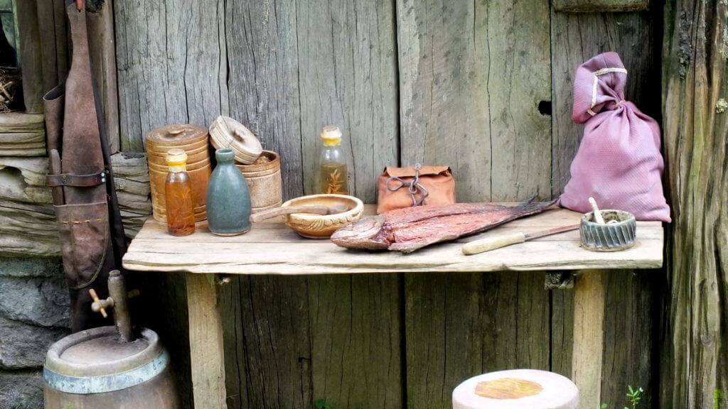 An image of a fish being filleted on a wooden table at Hobbiton in New Zealand. Photography by Frame To Frame - Bob and Jean.