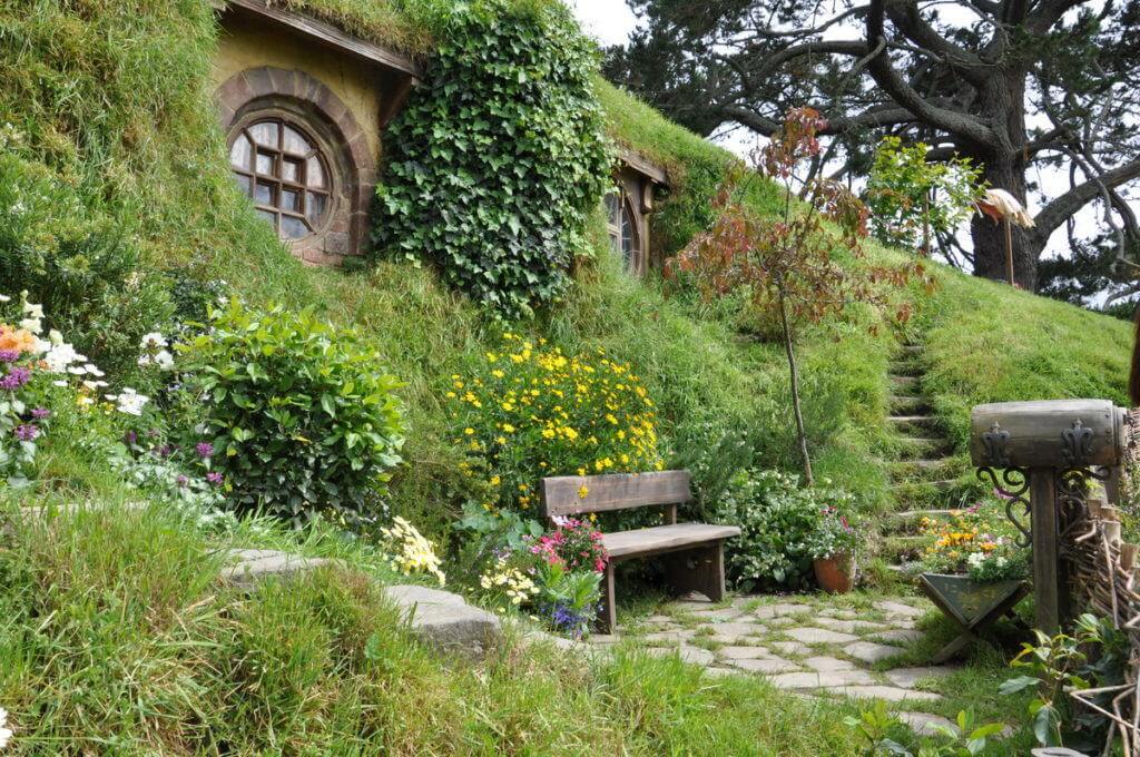 An image of flower gardens out front of Bilboo Baggins Home at Hobbiton in New Zealand. Photography by Frame To Frame - Bob and Jean.