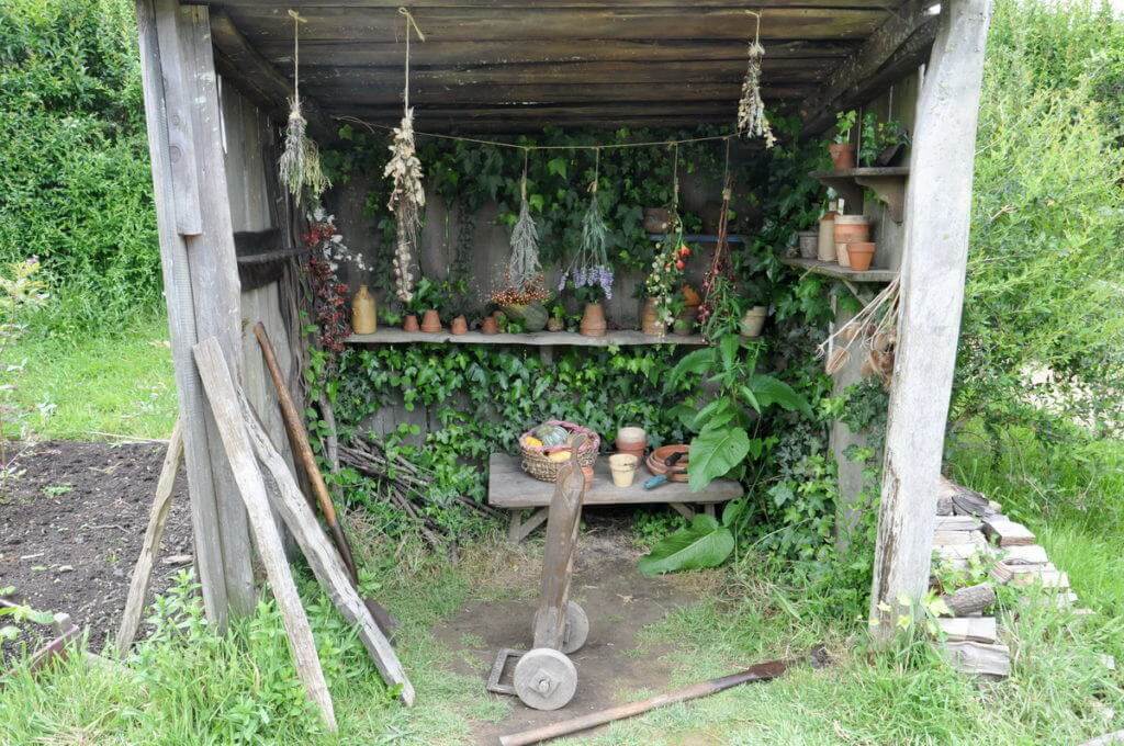 An image of a herbs drying in a wood shed hobbit hole beside a hobbit hole at Hobbiton in New Zealand. Photography by Frame To Frame - Bob and Jean.