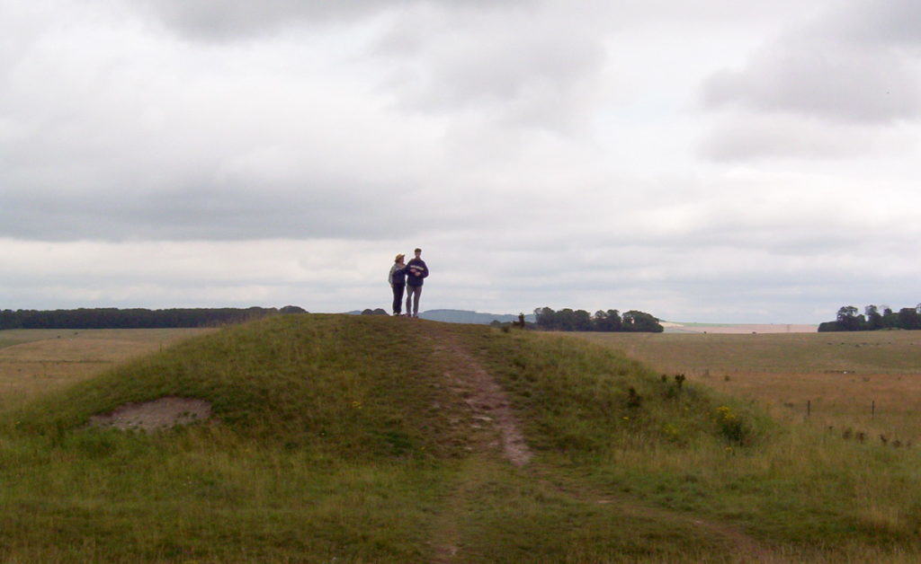An image of Jean and blake standing on a mound near Stonehenge in Wiltshire, England. Photography by Frame To Frame - Bob and Jean