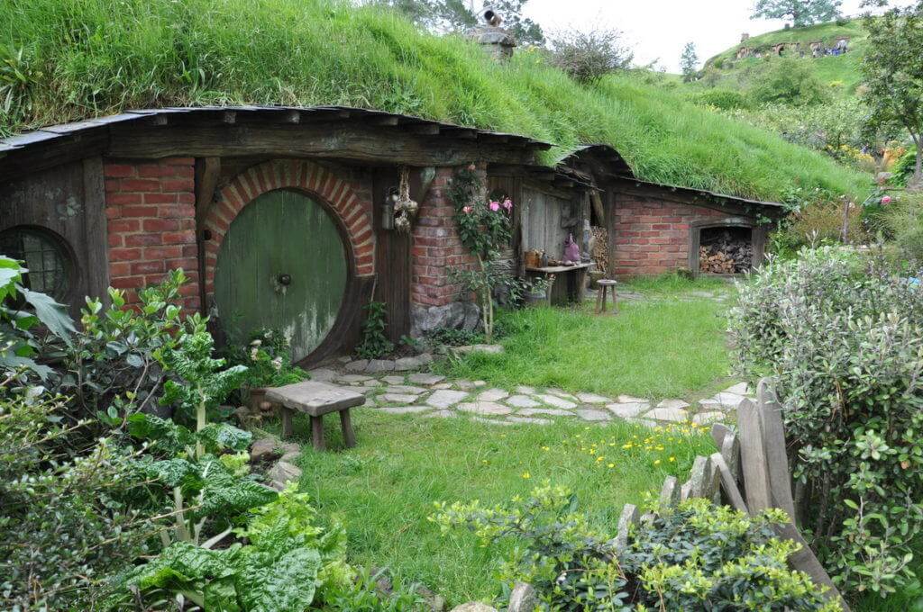 An image of a hobbit hole with a green door at Hobbiton, in New Zealand. Photography by Frame To Frame - Bob and Jean.