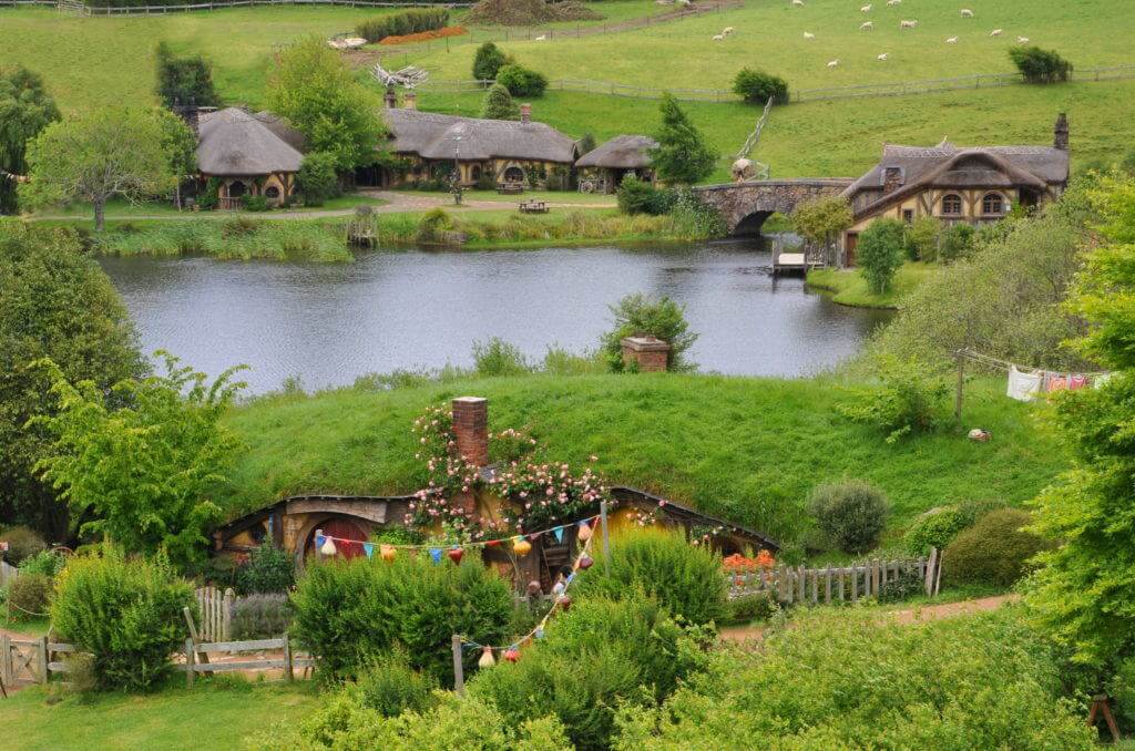 An image of the Green Dragon Inn on the pond at Hobbiton in Matamata, New Zealand. Photography by Frame To Frame - Bob and Jean