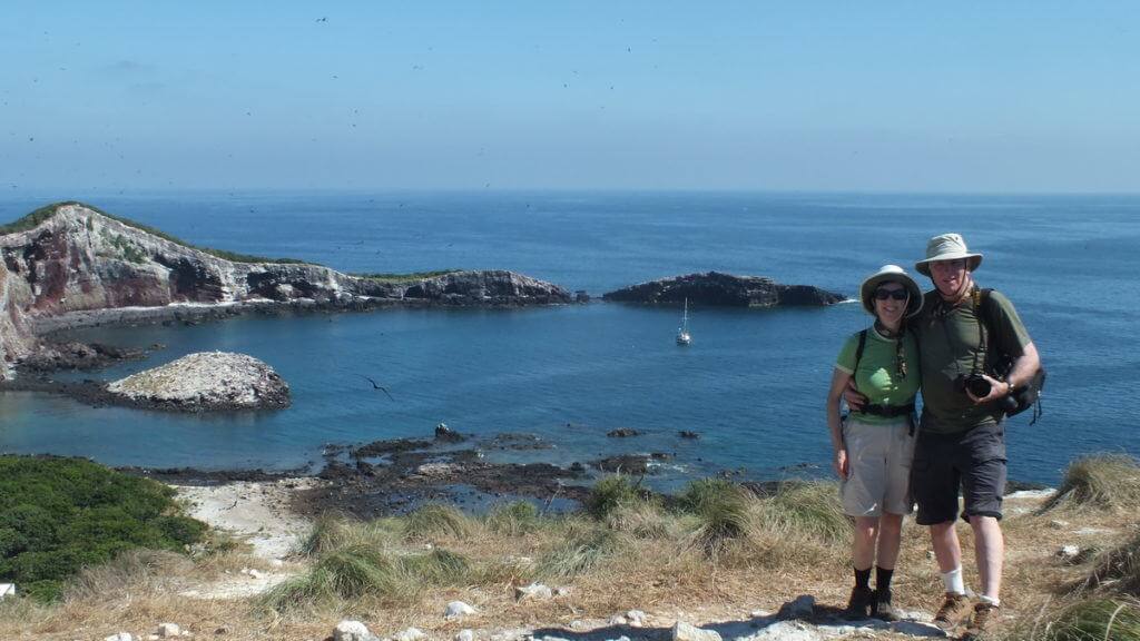 An image of Jean and Bob standing together on Isla Isabel with the inlet behind them. Photography by Frame To Frame - Bob and Jean.