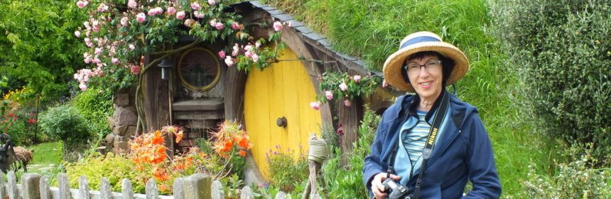 An image of Jean standing in front of Sams House at Hobbiton in New Zealand. Photography by Frame To Frame - Bob and Jean.