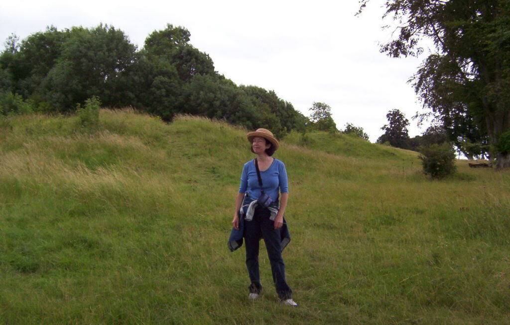 An image of Jean standing on a hiking trail near Stonehenge in Wiltshire, England. Photography by Frame To Frame - Bob and Jean