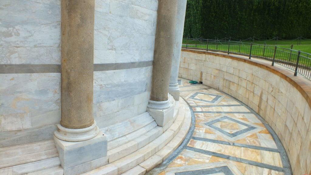 stone work at the base of the leaning tower of pisa, pisa, italy