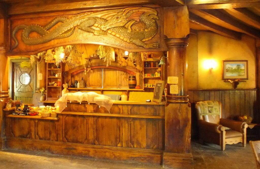 An image of the carved wooden green dragon inside the Green Dragon Pub at Hobbiton in Matamata, New Zealand. Photography by Frame To Frame - Bob and Jean