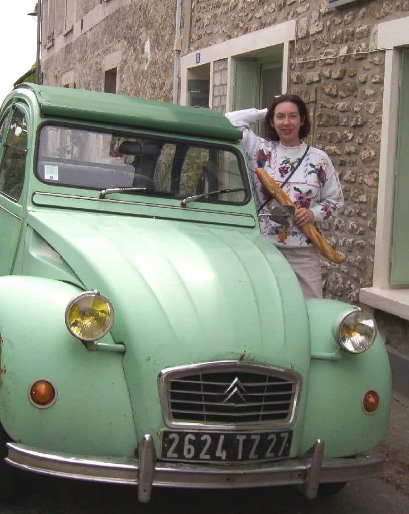 An image of Jean beside a vintage car in Giverny, France.