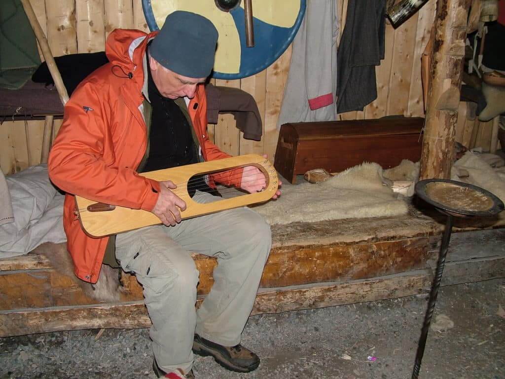 bob playing a viking harp at l'anse aux meadows, newfoundland, canada