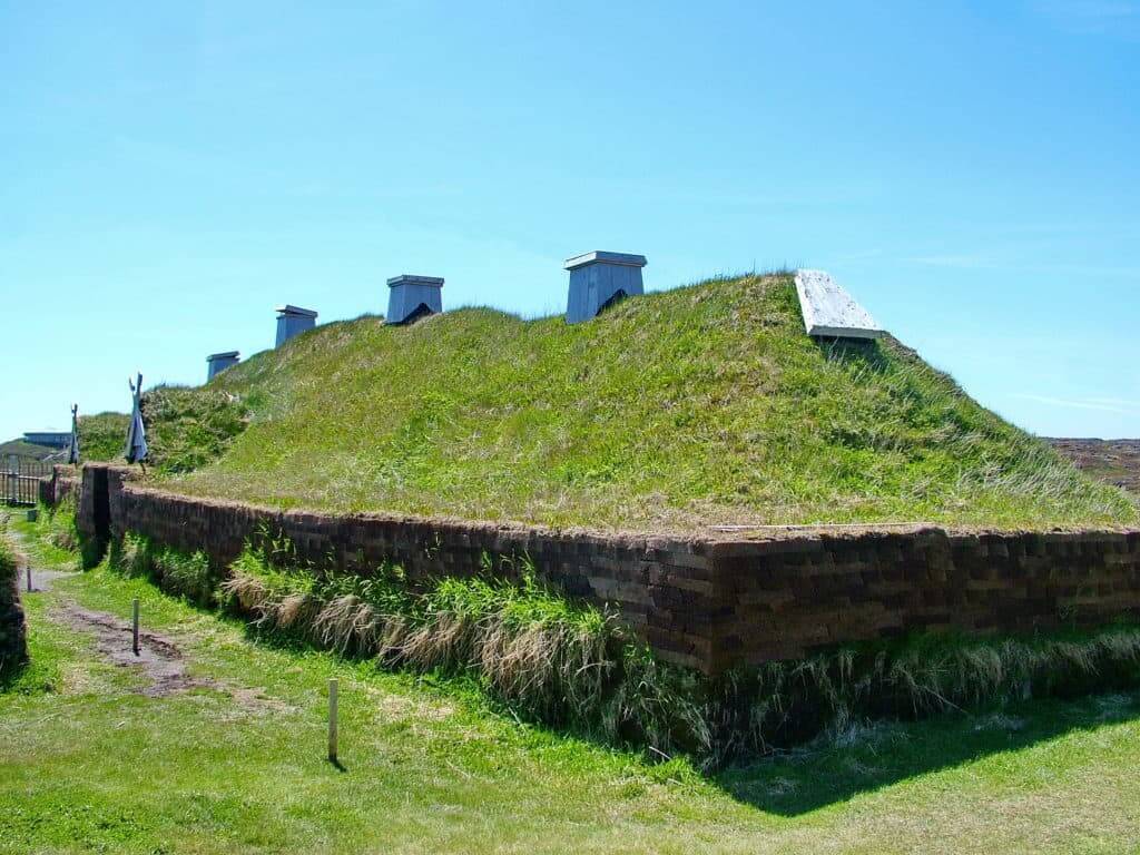 a re-created longhouse at l'anse aux meadows, newfoundland, canada