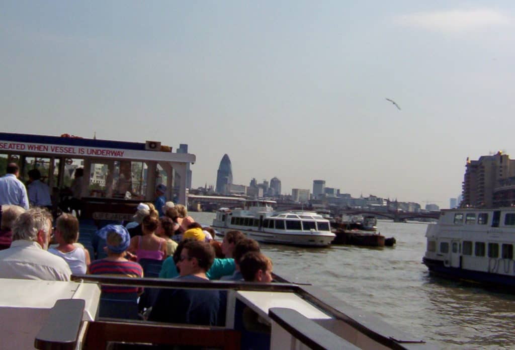 An image of a tour boat on the Thames River in London, England.