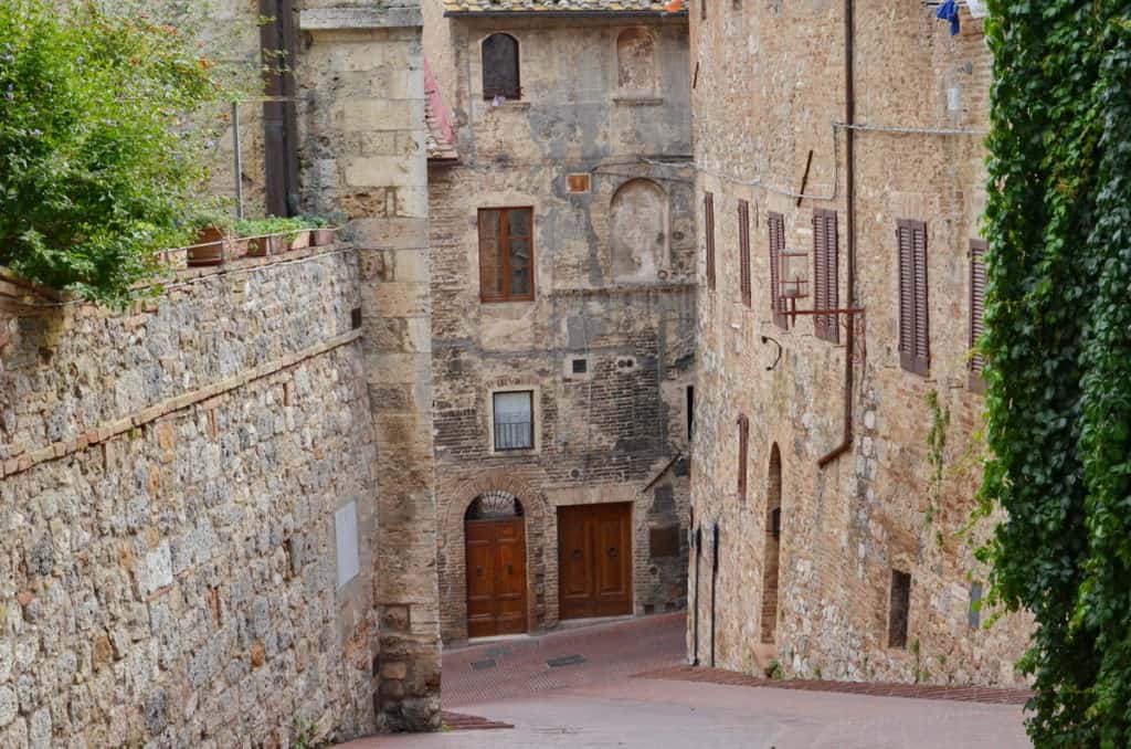 Image of the stone walls and buildings inside San Gimignano, Italy.