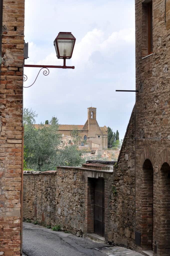 Image of stone walls and buildings inside San Gimignano, Italy.