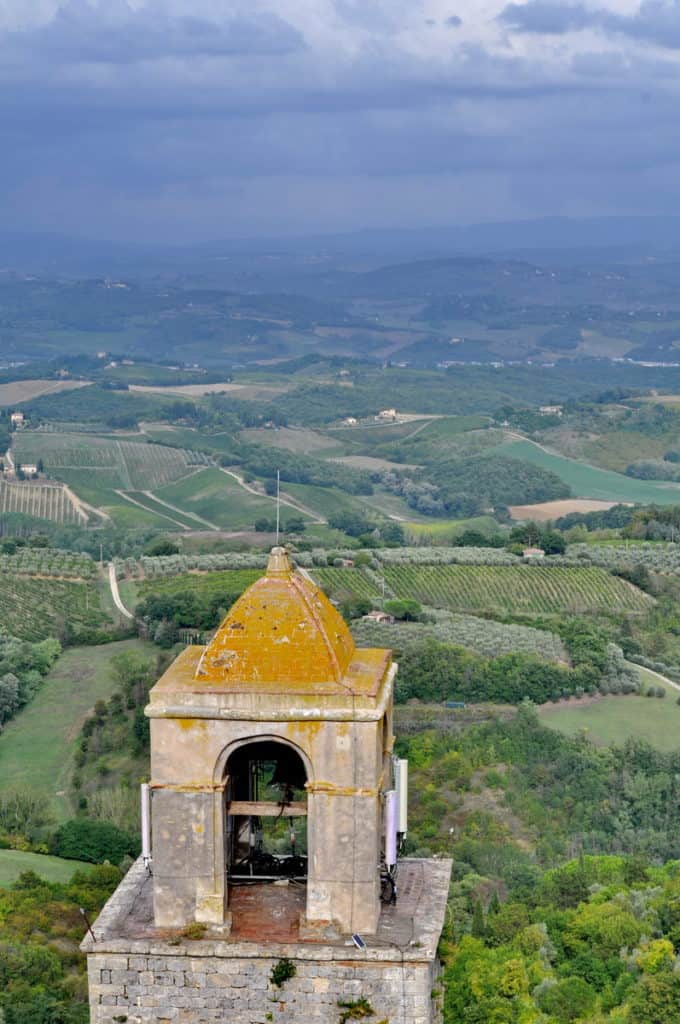 Image of the belfry on top of Torre Rognosa the most ancient tower in San Gimignano, Italy.