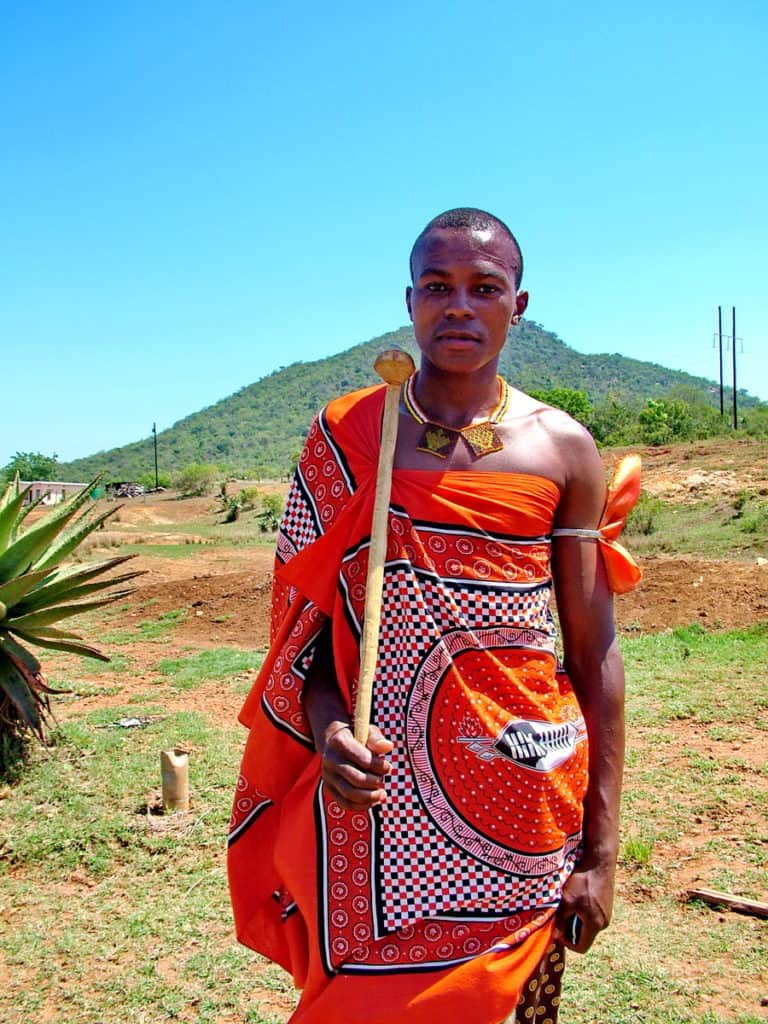 a young man in colourful traditional dress in swaziland, africa