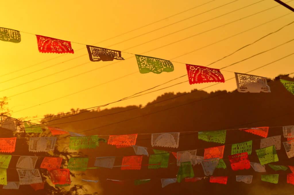 Image of ornate paper bunting at dusk in La Bajada, Mexico.