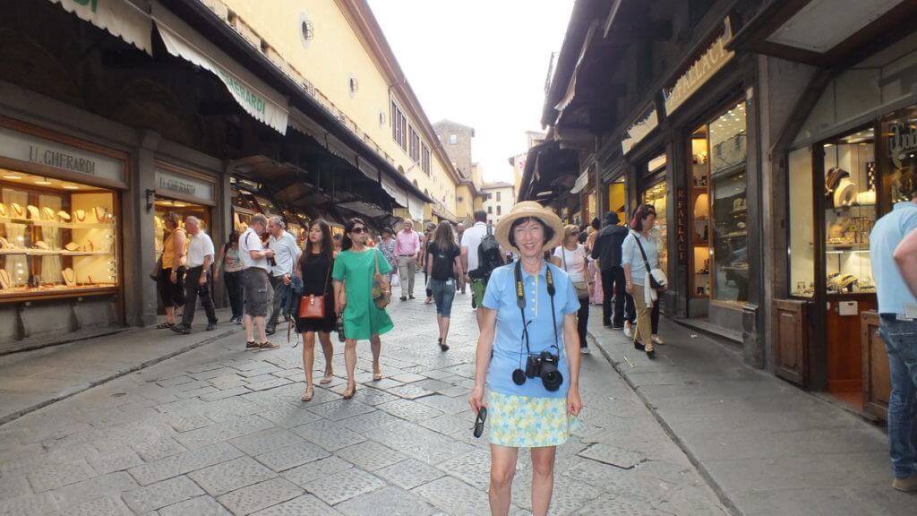 jean and shops on ponte vecchio, florence, italy