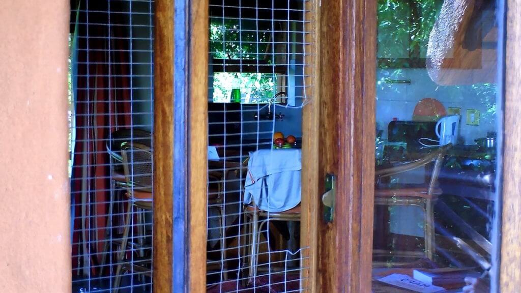 windows with chicken wire at hilltop camp, hluhluwe-imfolozi, south africa