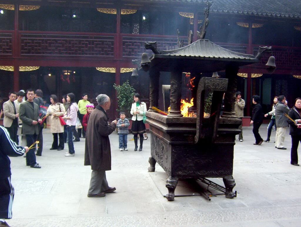 People standing around the altar outside the City God Temple of Shanghai