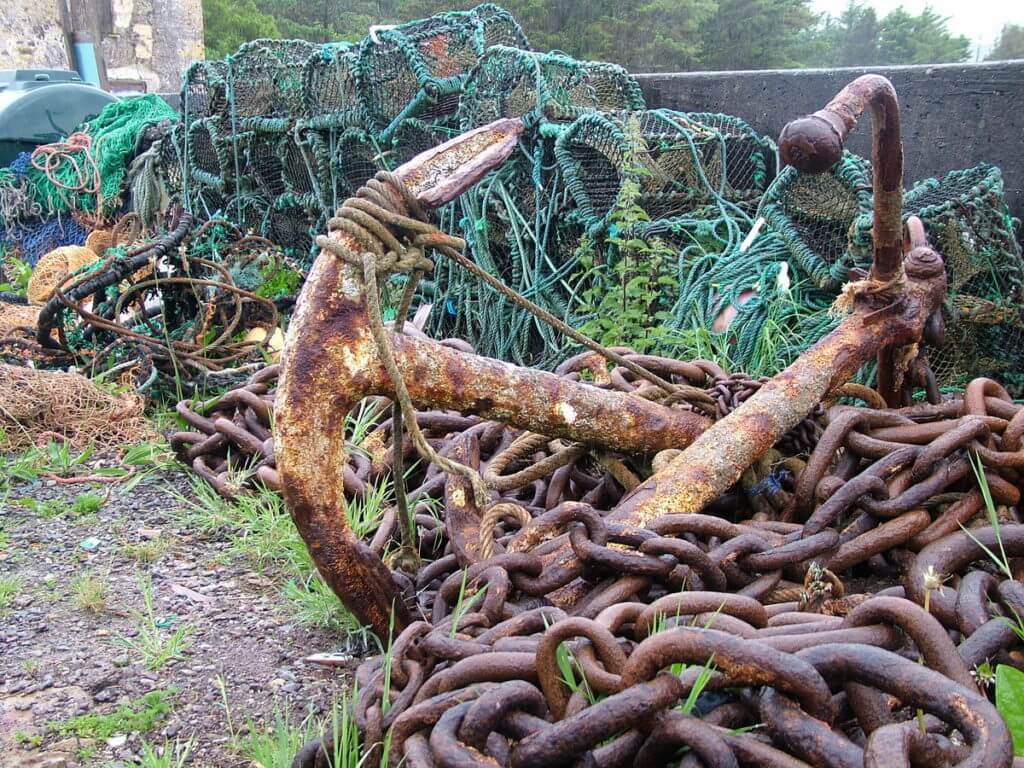 a rusty anchor and chains and lobster traps, ballinskelligs, ireland