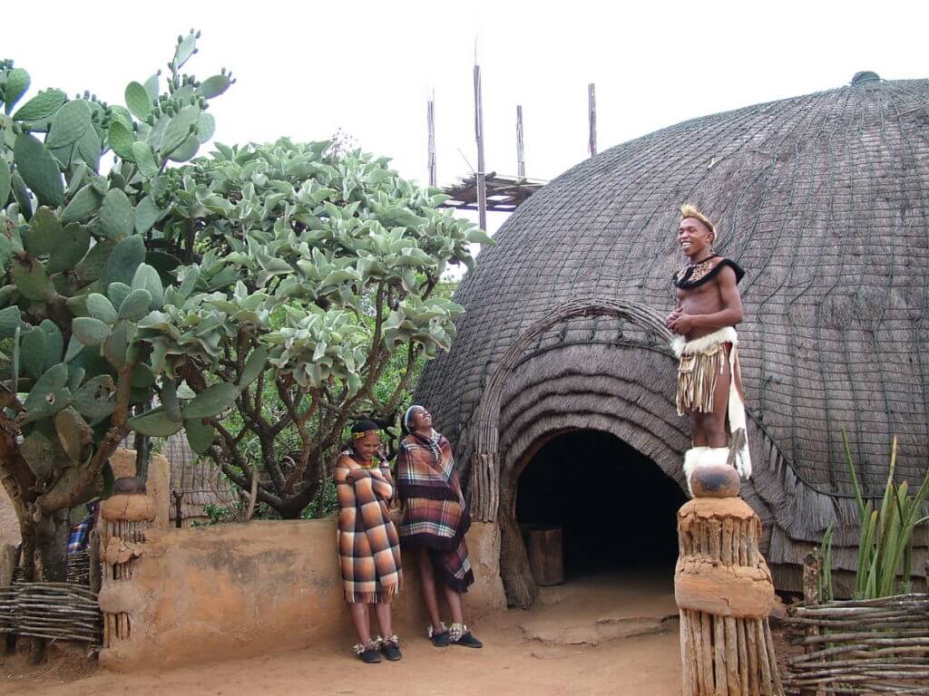 a zulu warrior sharing a laugh, shakaland, kwazulu-natal, south africa 