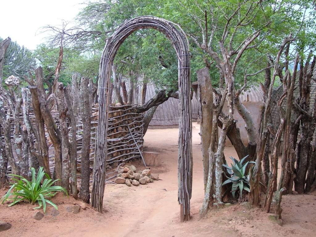 arch and fencing inside the kraal, shakaland, kwazulu-natal, south africa