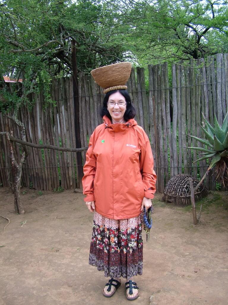 jean with a woven basket on her head, shakaland, kwazulu-natal, south africa