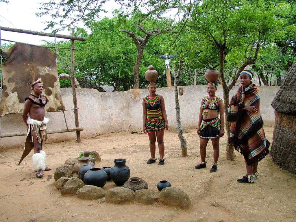 zulu maidens carrying clay pots on their heads, shakaland, kwazulu-natal, south africa