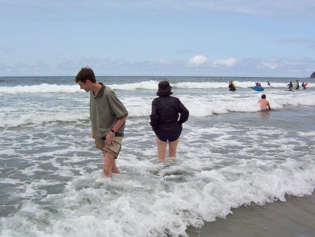 jean and her son wading, trebarwith strand beach, cornwall, england
