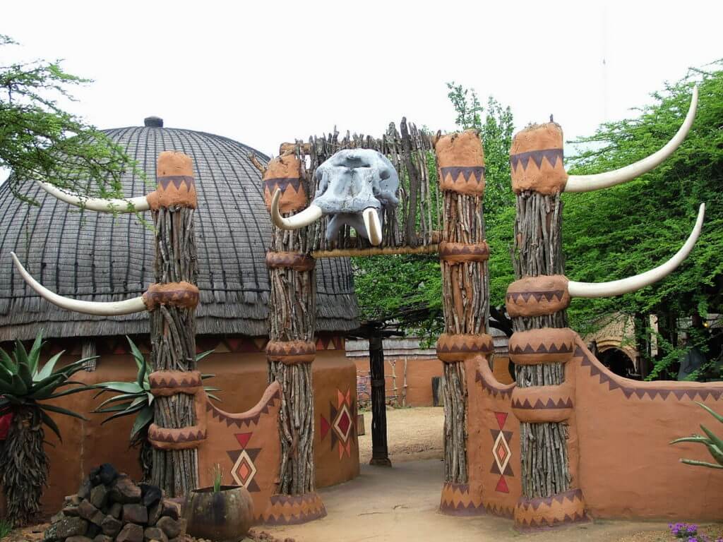 a portal crowned with an elephant's skull, shakaland, kwazulu-natal, south africa