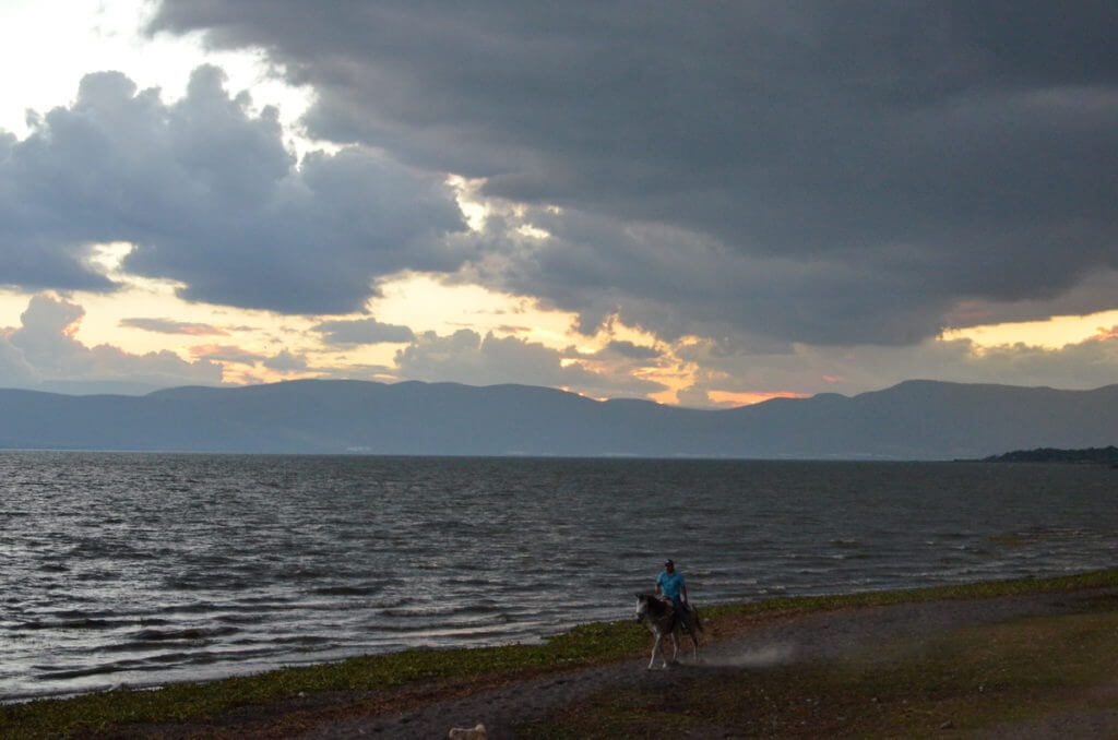 horseback rider at sunset, lake chapala, mexico
