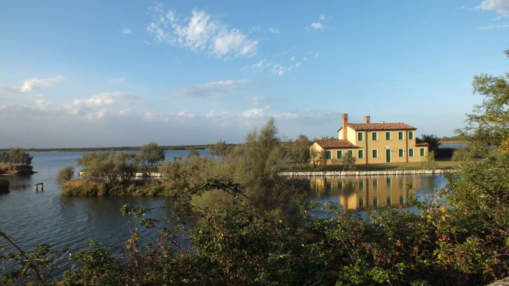 a home reflected in the water, Parco Regionale Veneto del Delta del Po (The Regional Park of the Po River Delta), italy