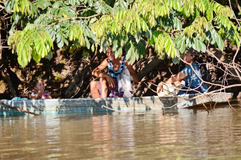 fisherpeople with a freshwater drum fish, rio frio, cano negro wildlife refuge, costa rica