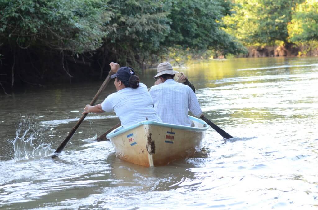 people paddling a boat, rio frio, cano negro wildlife refuge, costa rica