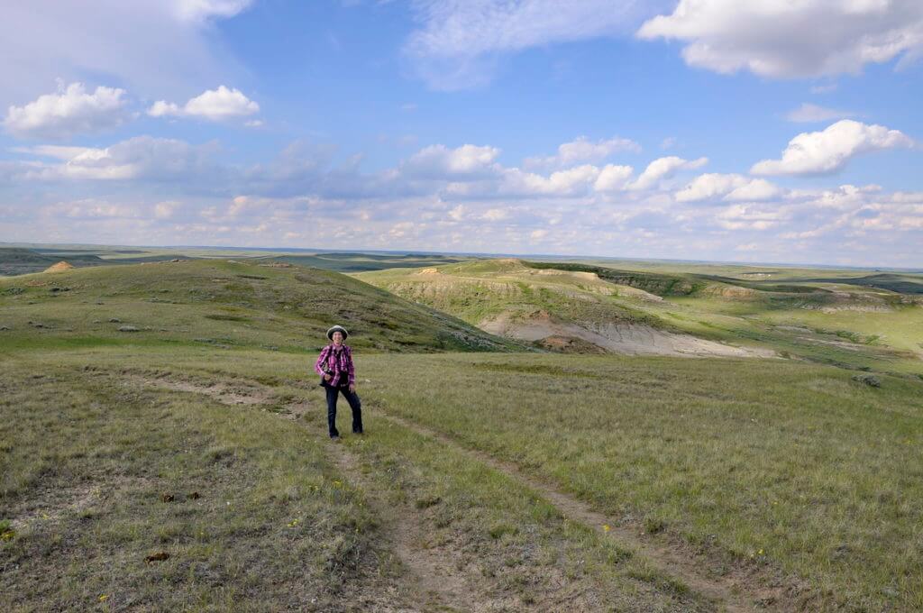 Image of jean standing along the valley of 1000 devils route, grasslands national park east block, saskatchewan