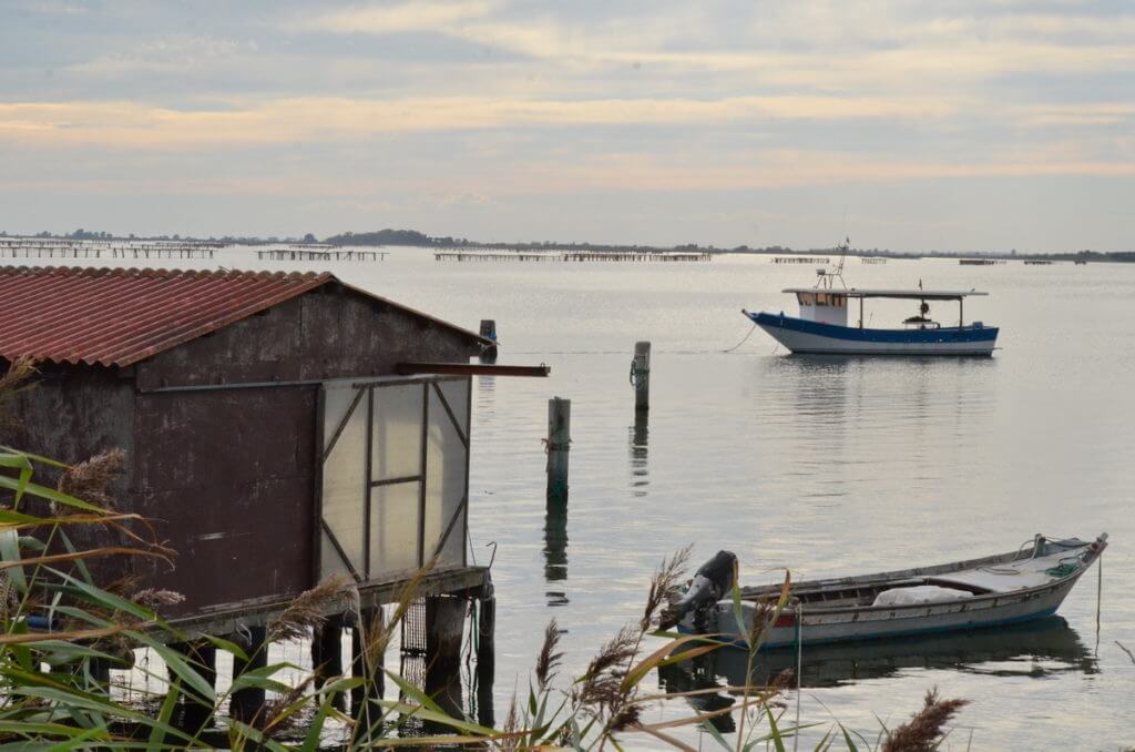 fishing house and boats, parco regionale veneto del delta del po, po river delta, italy 