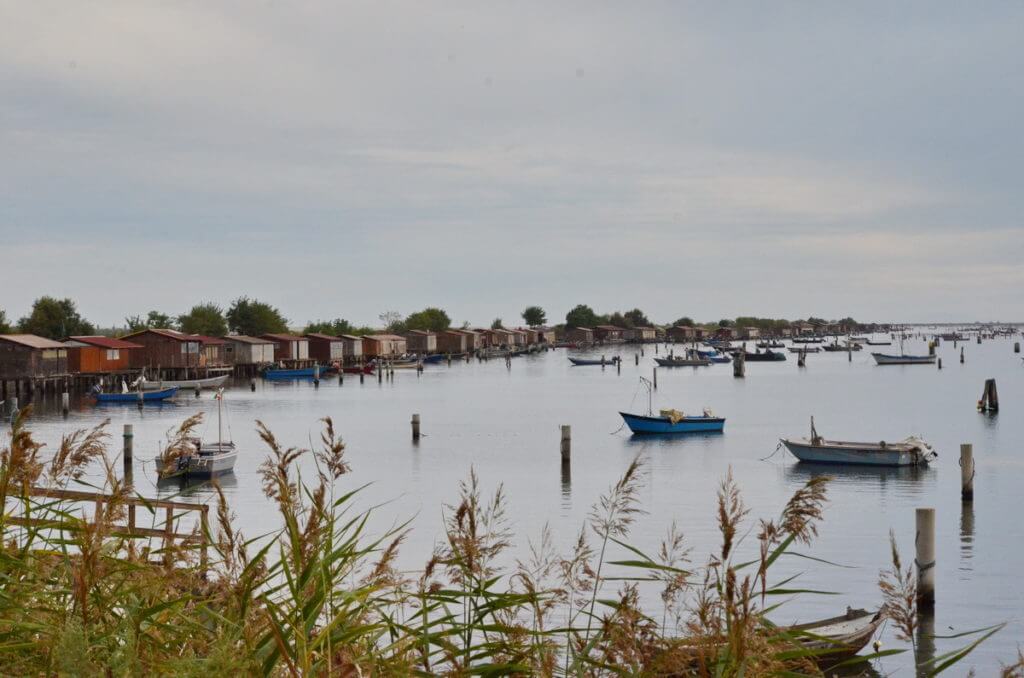 fishing houses and boats, parco regionale veneto del delta del po, po river delta, italy 